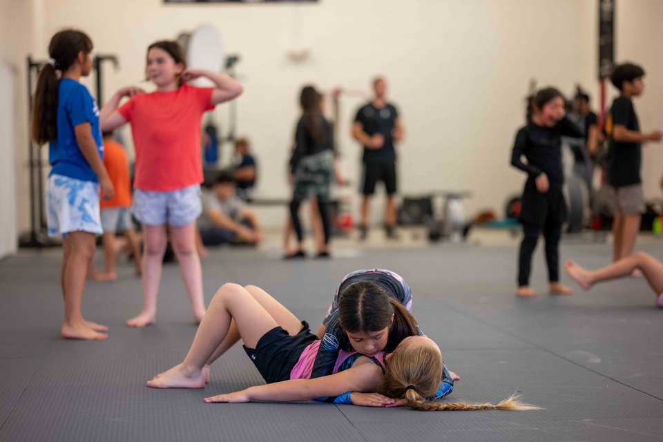 Children practicing grappling together in a Tillis kids class